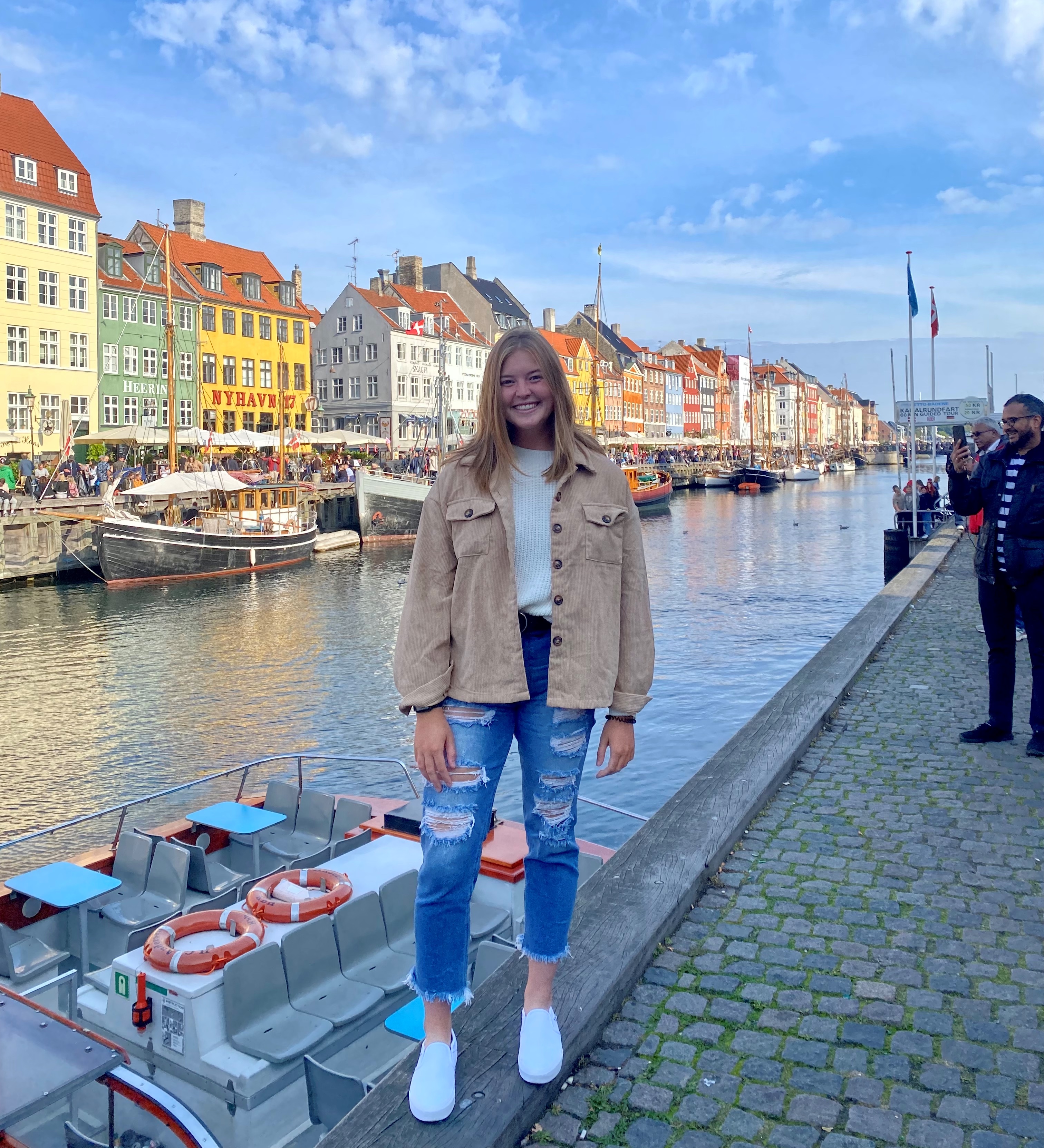 A student poses in Copenhagen's Nyhavn.