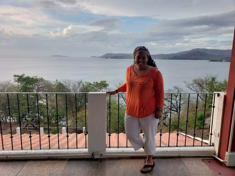 Student poses for a picture with the Costa Rican coast.